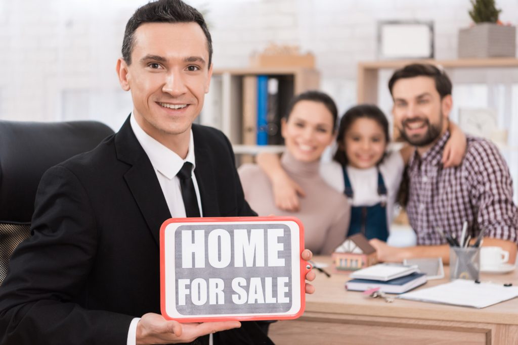 Image depicting a person reviewing a checklist with the title 'Common Mistakes to Avoid When Selling Your Property' alongside a group of estate agents in Barking discussing strategies.